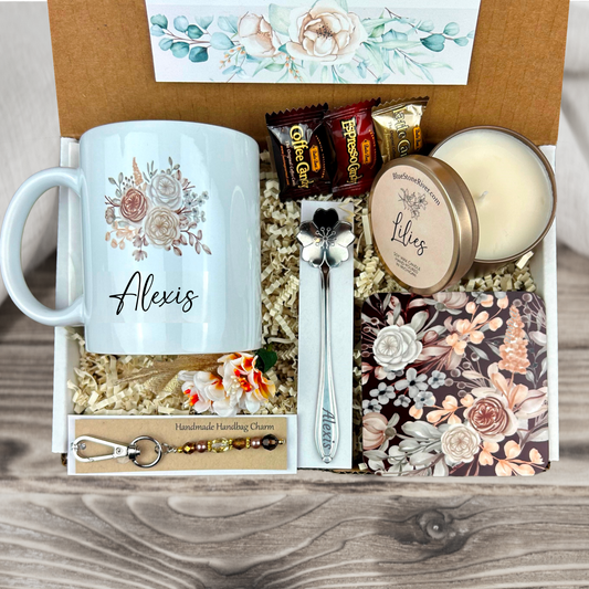 gift basket with a personalized mocha bloomcoffee mug, engraved spoon, vibrant coaster, scented candle, artisan charm, and coffee treats for women’s present