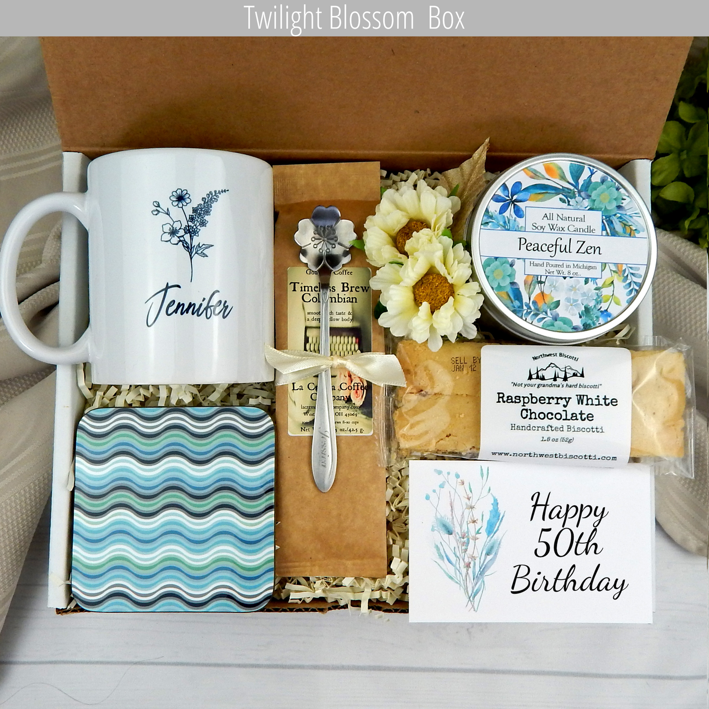 Warm wishes for 50: Birthday gift basket for her with a personalized name mug, coffee, comforting goodies, engraved spoon, and candle.
