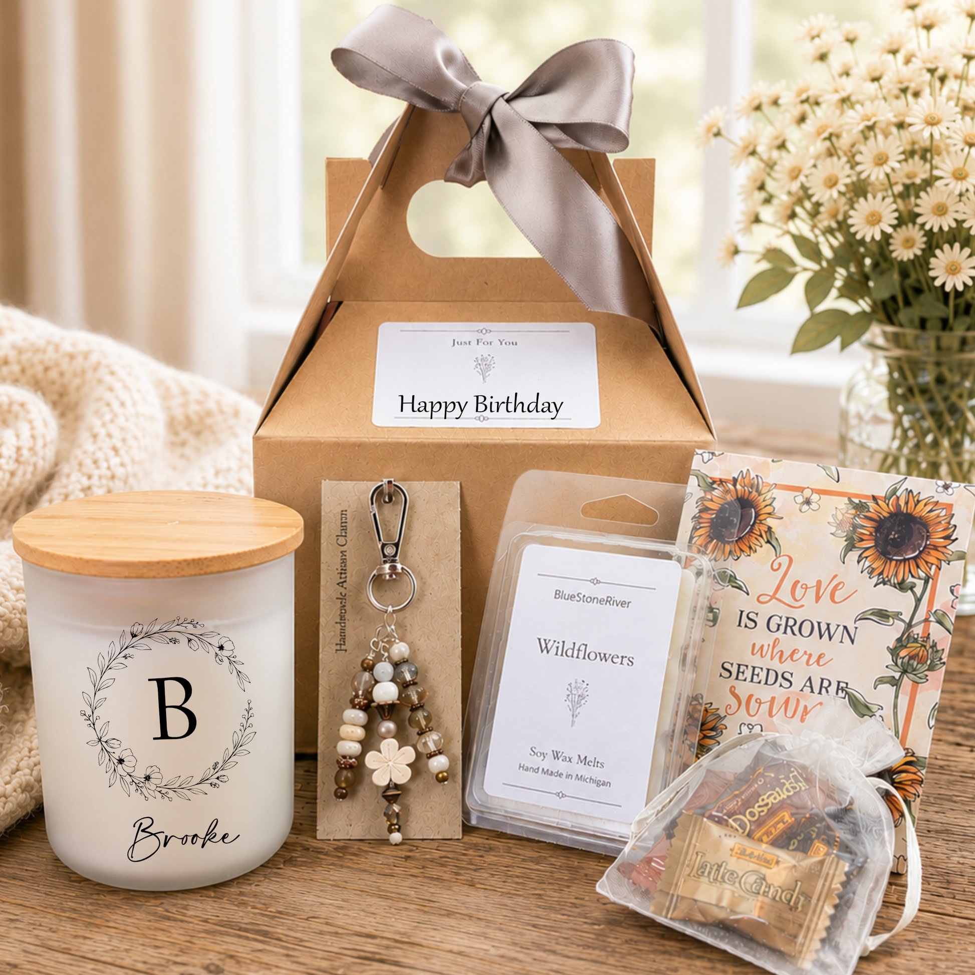 Birthday Gift set with candle, artisan purse charm, candies and cards on a wooden surface.