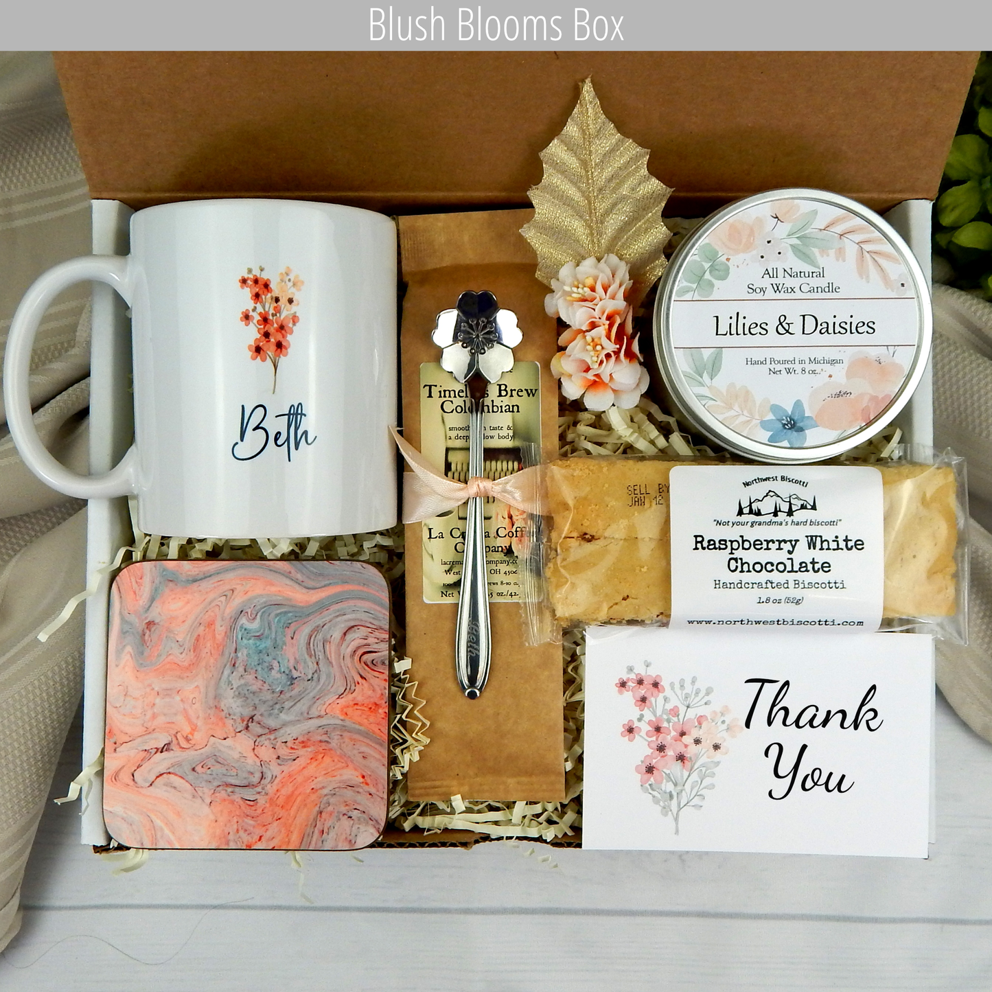 Expressing gratitude: Women's gift box with custom name mug, candle, engraved spoon, biscotti, and coffee.