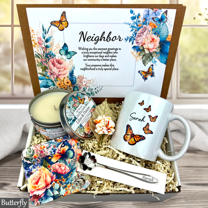 Gift box with 'Congratulations' card, mug, candle, and other items with butterfly design.