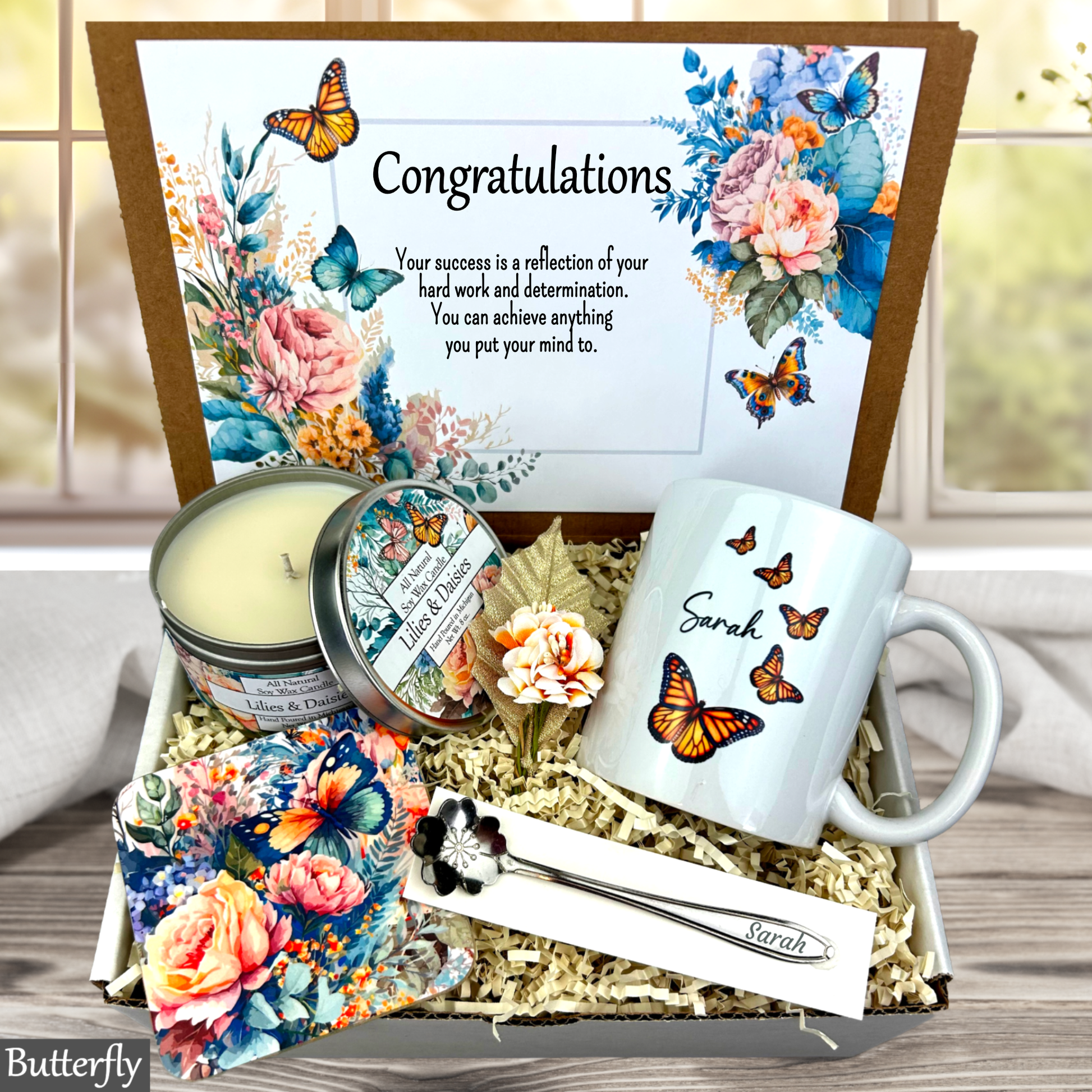 Butterfly Gift box with 'Congratulations' card, mug, candle, and other items with butterfly design.