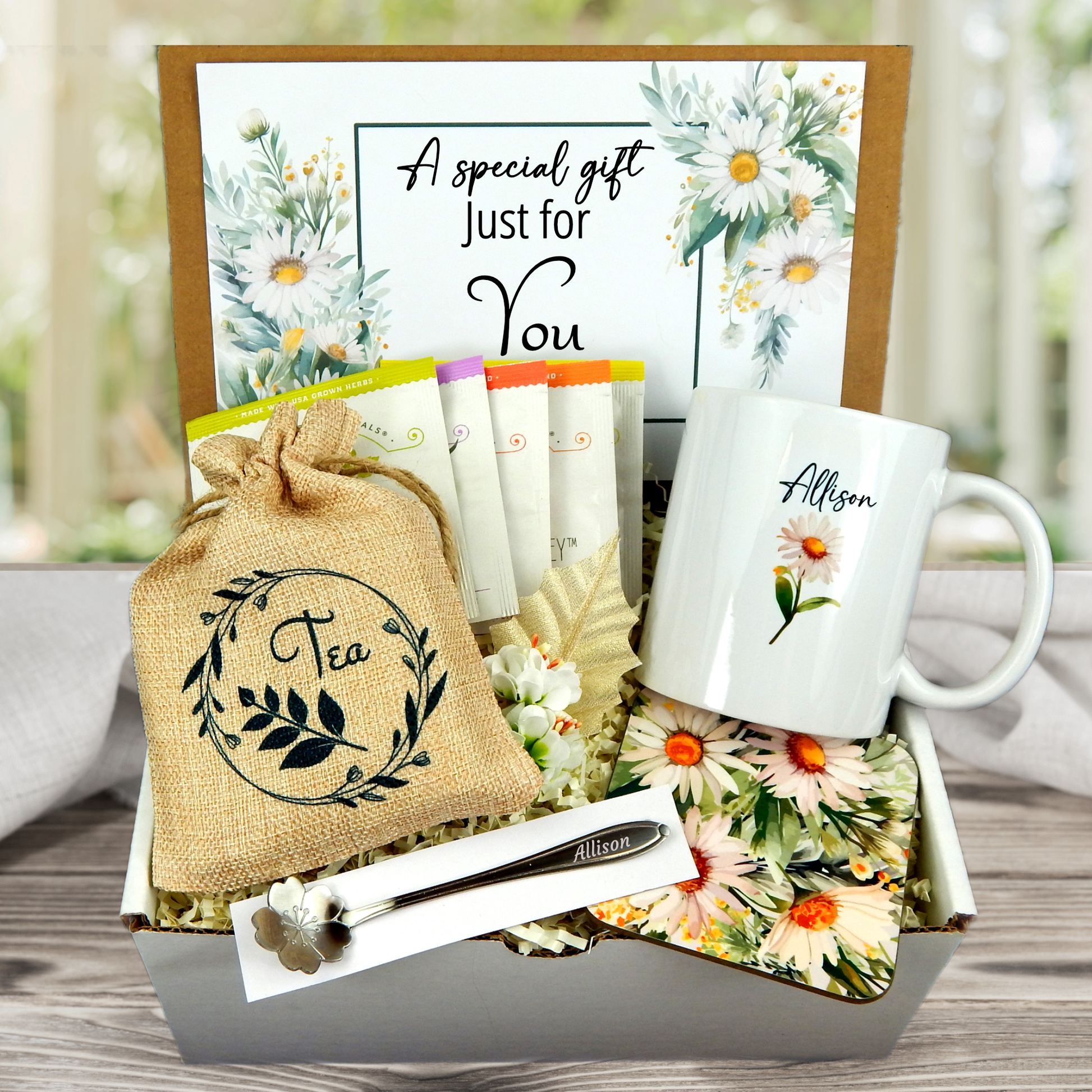 daisy themed Personalized mug and engraved spoon set accompanied by a large 8-ounce scented candle, an assortment of five artisan teas, and a matching coaster set for any occasion