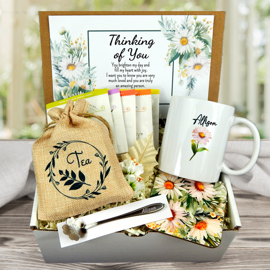 Daisy themed thinking of you gift basket with personalized mug, custom coaster, assorted tea selection, personalized card, flower design