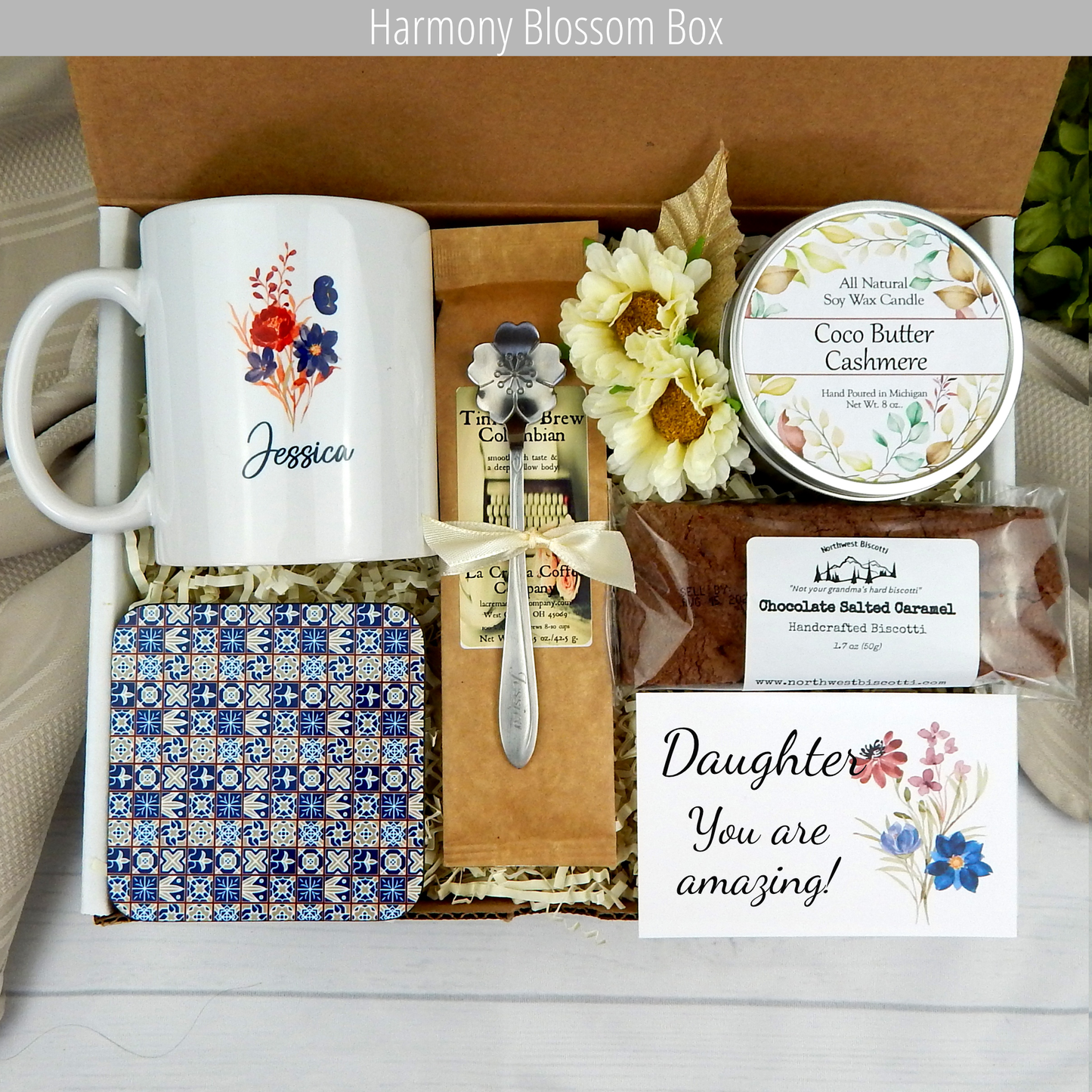 Celebrate special moments: Personalized name mug, candle, engraved spoon, biscotti, and coffee in a daughter's gift basket.