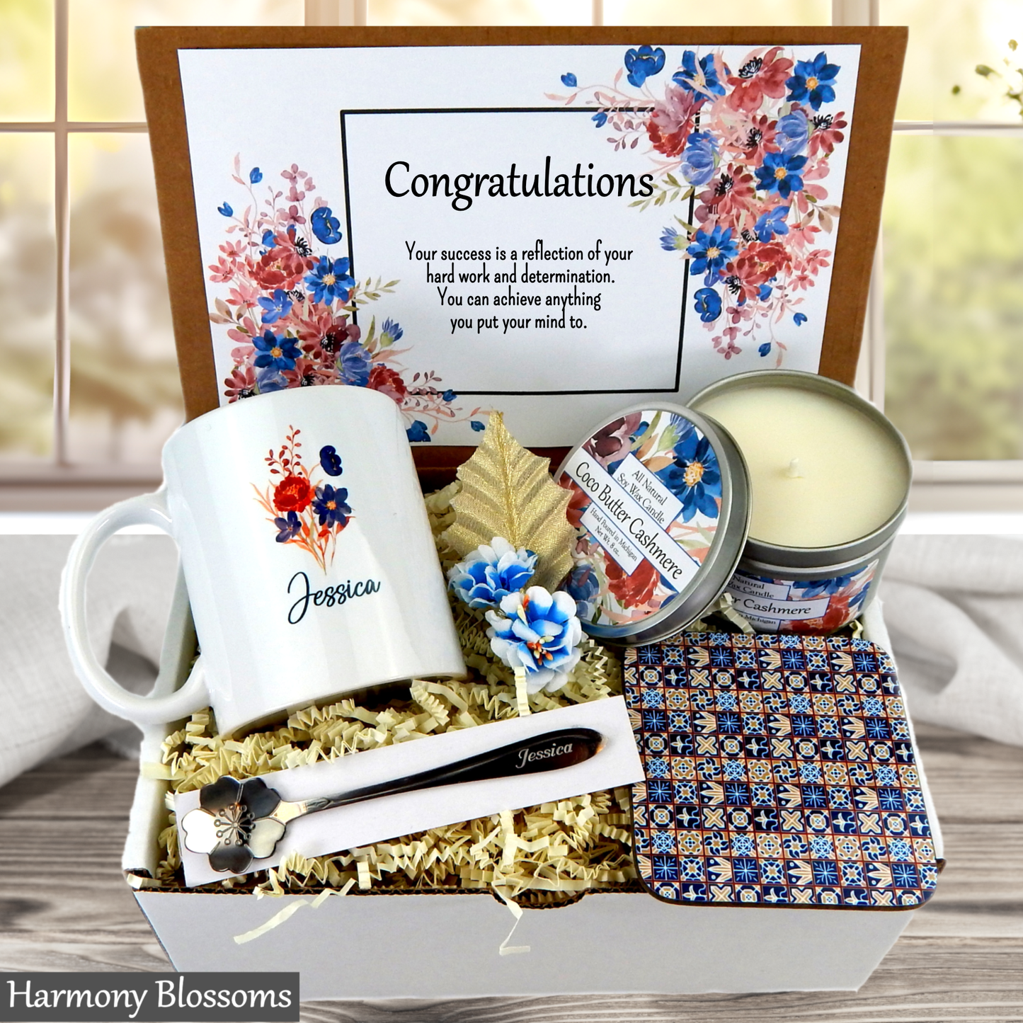 Gift basket with mug, candles, and decorative items with 'Harmony Blossoms' branding.