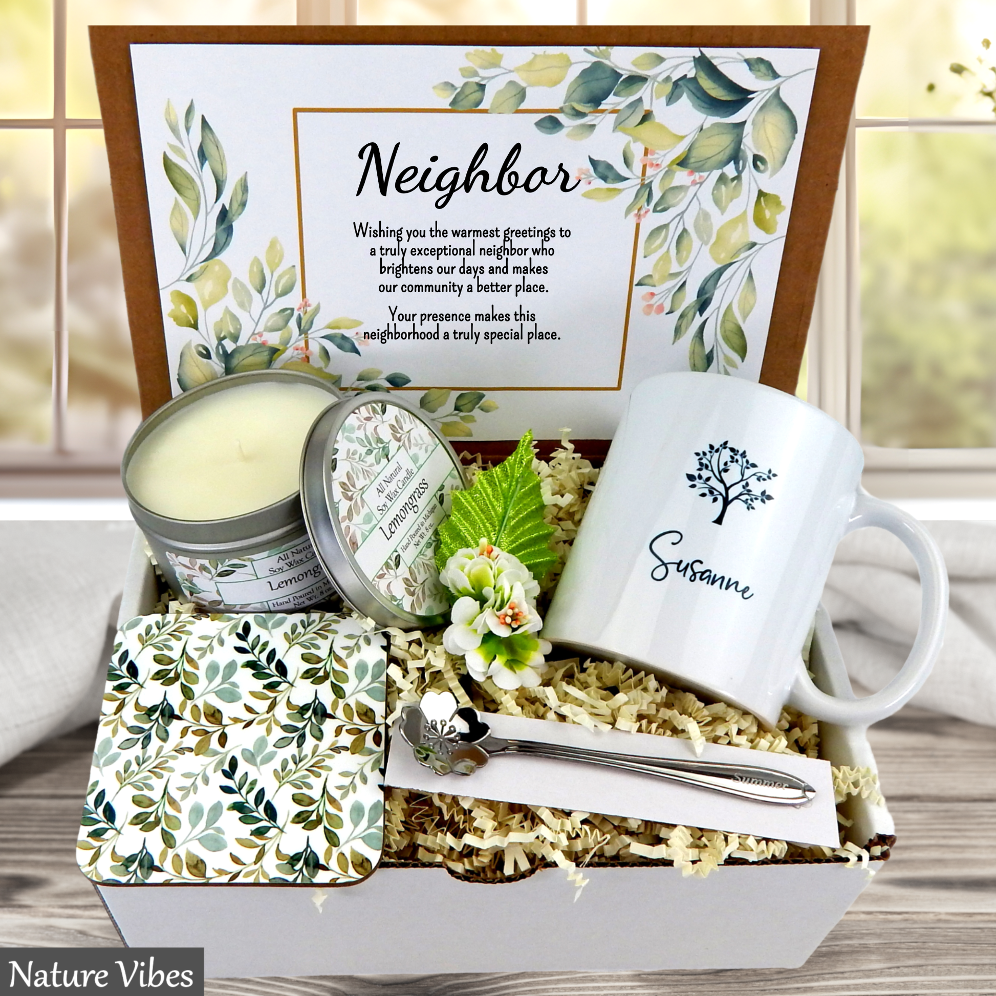 Neighborhood gift set with mug, candle, and coasters in a box, featuring a personalized message.