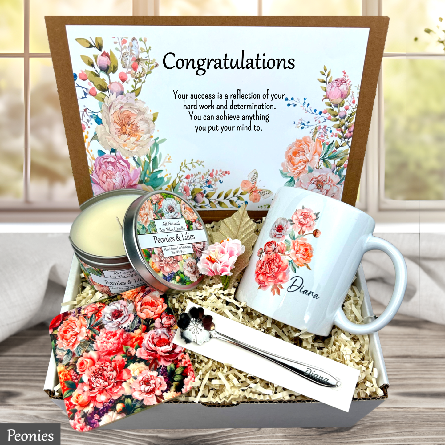 Peonies Gift set with floral-themed mug, candles, and card on a wooden surface.