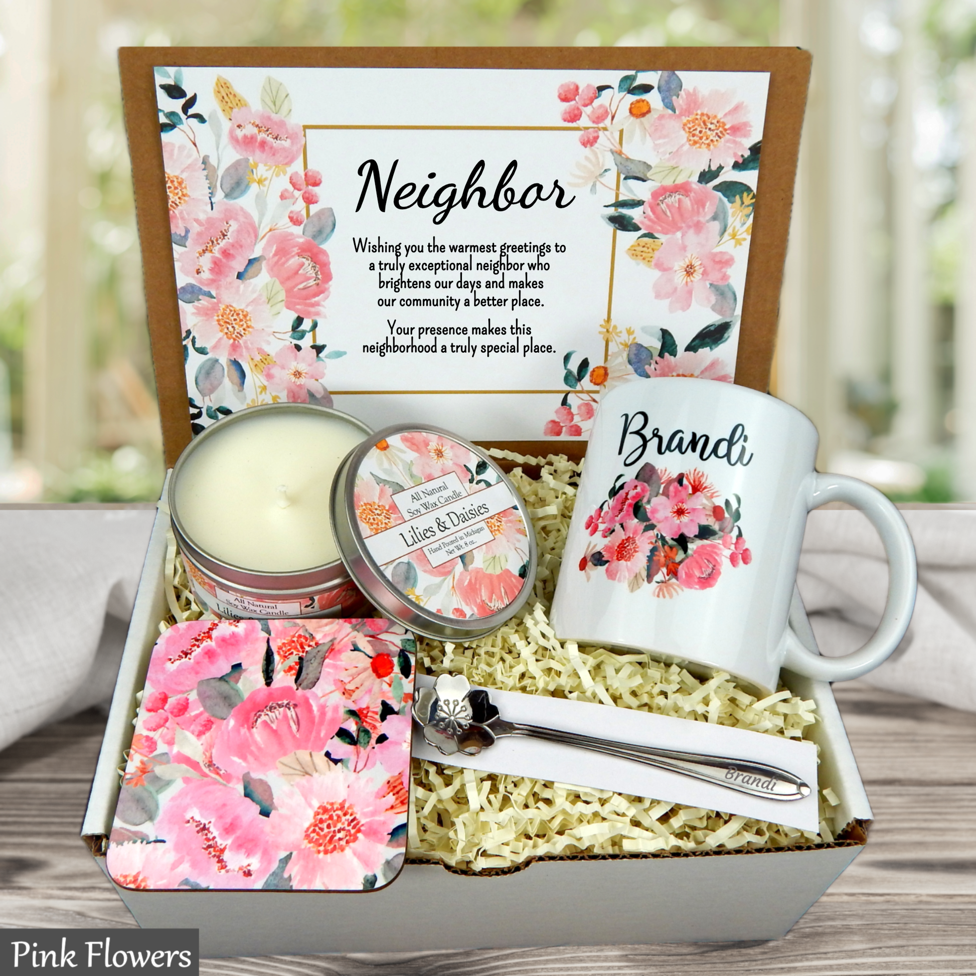 Gift set with mug, candle, and other items in a decorative box with floral design and 'Congratulations' message.