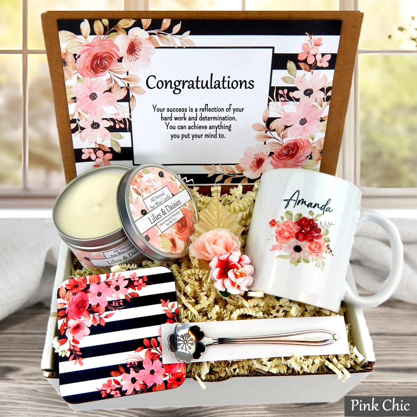 Gift set with mug, candles, and card in a decorative box, featuring floral designs and 'Pink Chic' branding.
