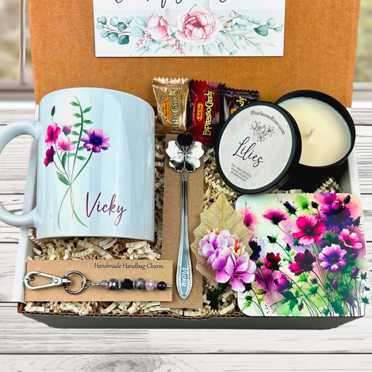 purple flower gift basket with personalized mug, candle, engraved spoon, matching coaster and scented candle.