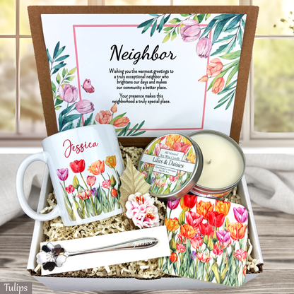 Gift set for a neighbor with mug, candle, and card on a wooden surface.