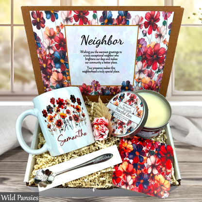 Neighborhood gift set with mug, candles, and cards featuring floral designs and text.