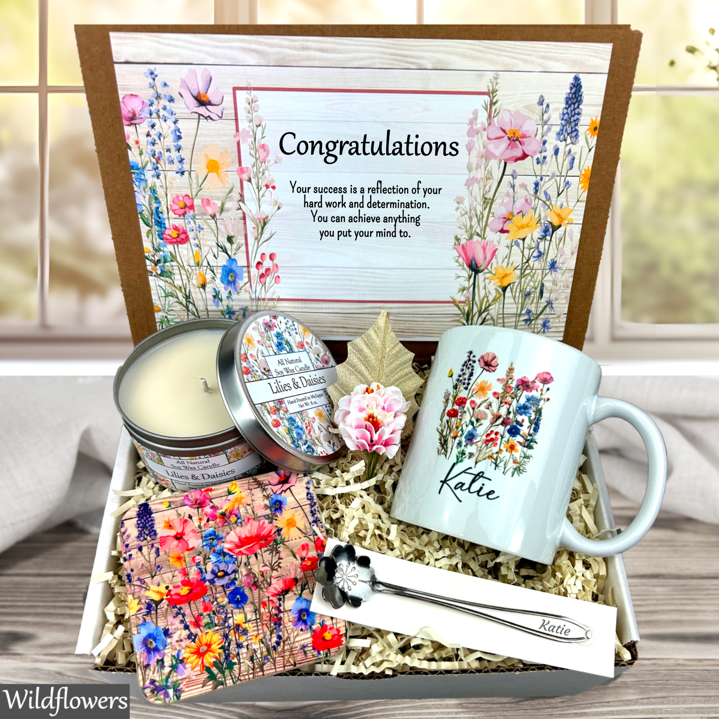 Wildflower 
Gift set with mug, candle, and card in a decorative box, featuring floral designs and 'Congratulations' message.