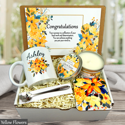 Gift set with mug, candle, and other items in a decorative box with yellow floral design.